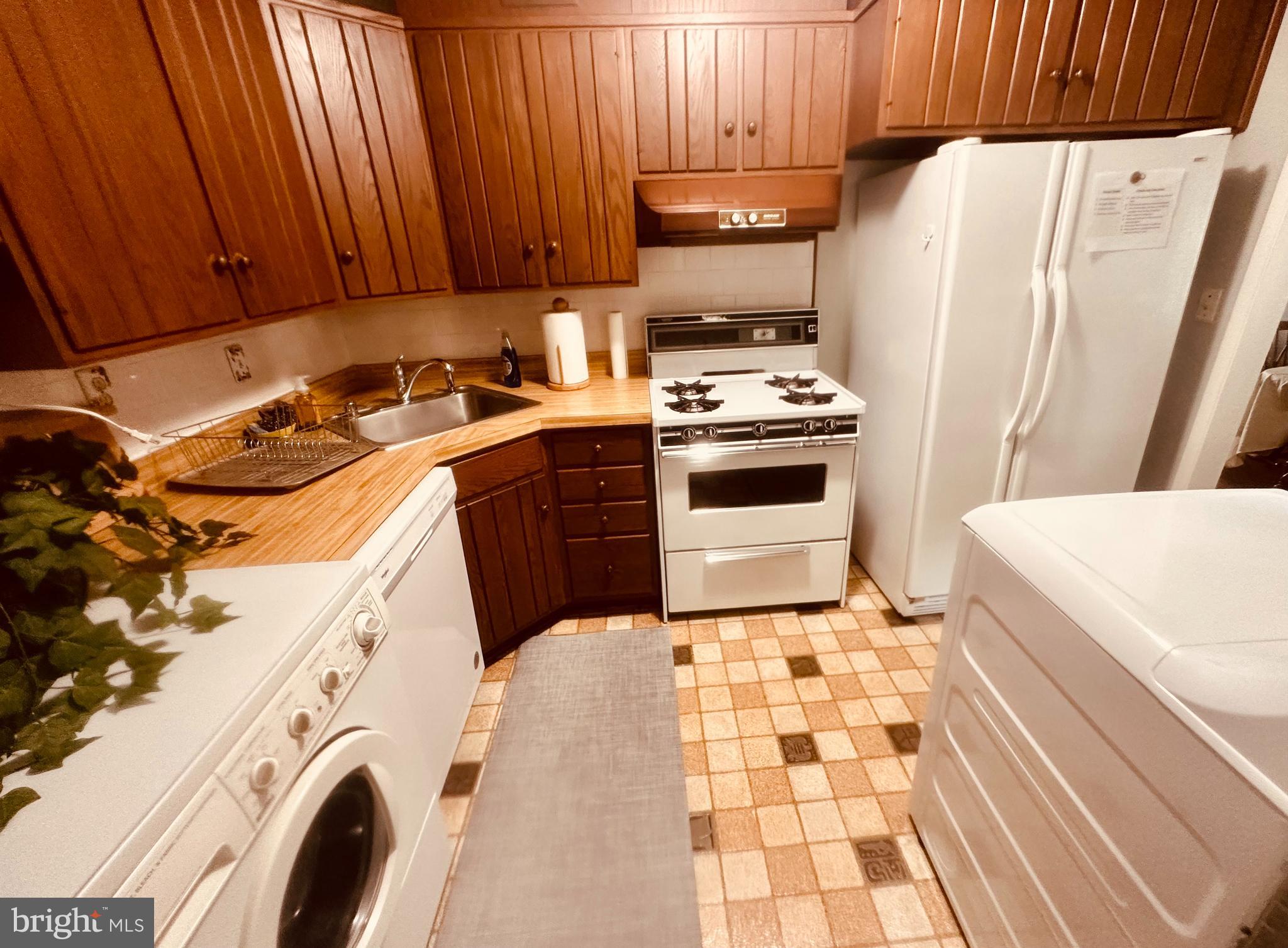 1813 Olmstead Drive Falls Church, VA 22043 - Photo 10 of 14 a kitchen with a stove a sink and a refrigerator
