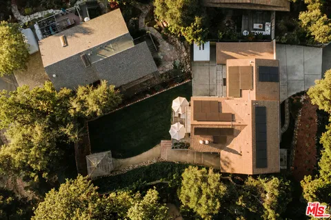 an aerial view of a house with a yard