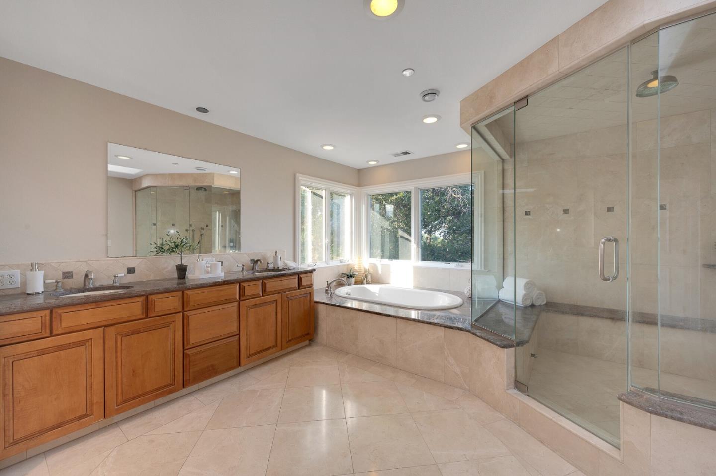 21401 Prospect Road Saratoga, CA 95070 - Photo 20 of 26 a large bathroom with a granite countertop tub sink shower and mirror
