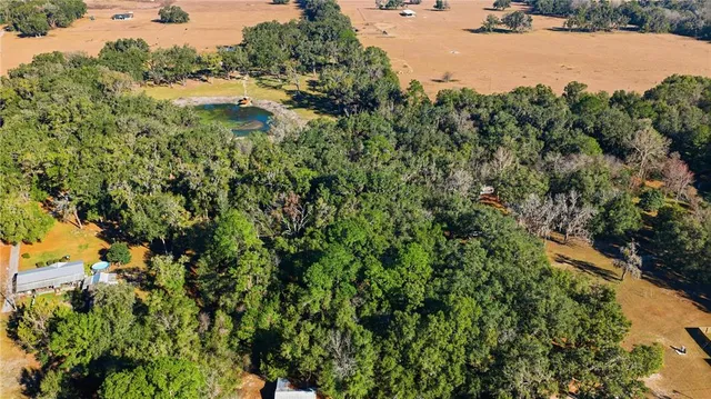 an aerial view of a houses with yard