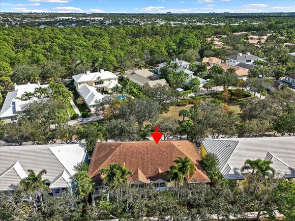 an aerial view of residential houses with outdoor space and swimming pool