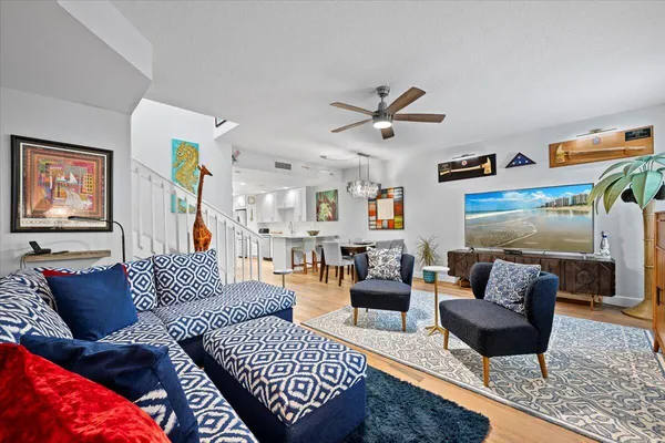 a living room with furniture and wooden floor
