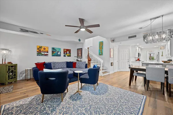 a living room with furniture and a chandelier
