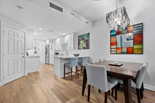 a view of a dining room with furniture and chandelier