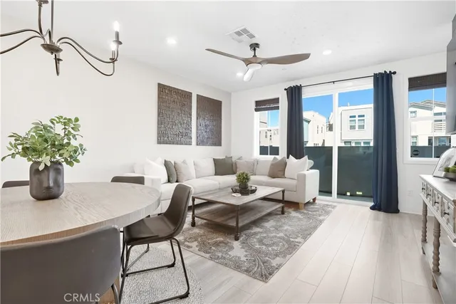 a living room with furniture and a potted plant