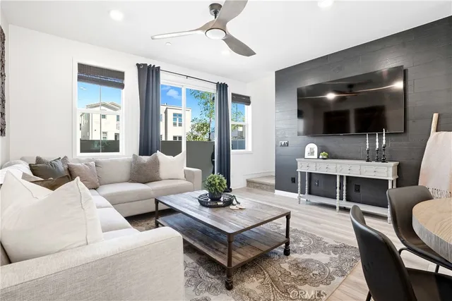 a living room with furniture and view of kitchen