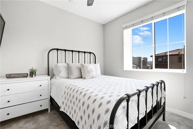 a bedroom with a bed and window