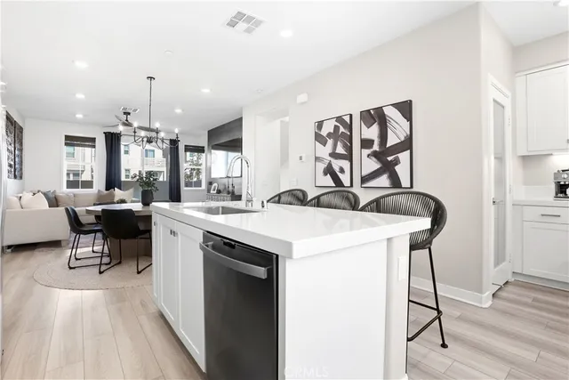 a kitchen with a sink cabinets and wooden floor