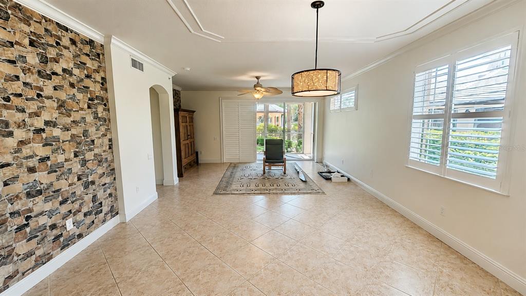 6552 Moorings Point Circle, Unit 102 Lakewood Ranch, FL 34202 - Photo 3 of 57 a view of a hallway with windows and chandelier