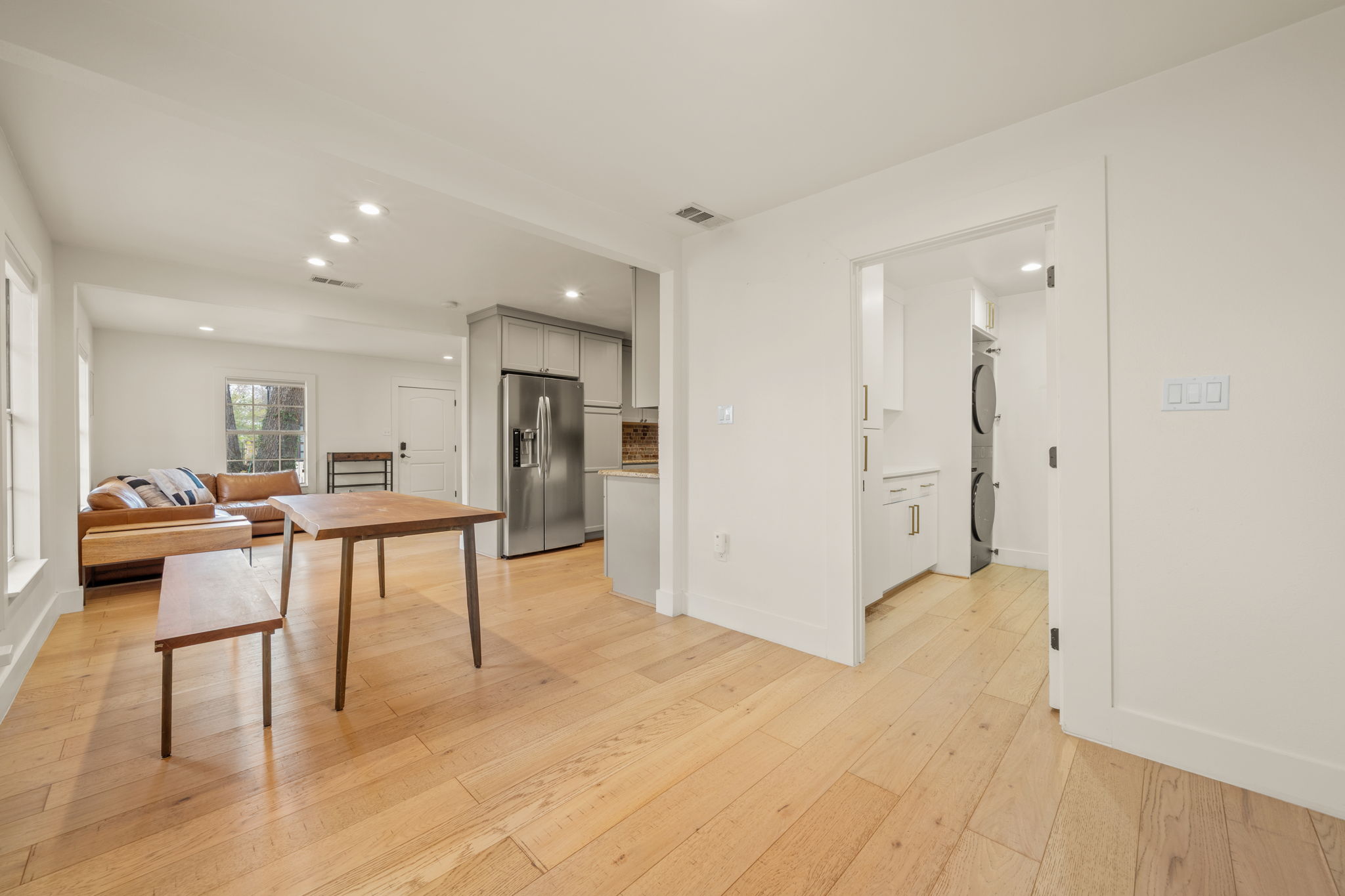 912 Mansell Avenue Austin, TX 78702 - Photo 16 of 37 Dining area with stacked washing machine and dryer, recessed lighting, and light wood finished floors