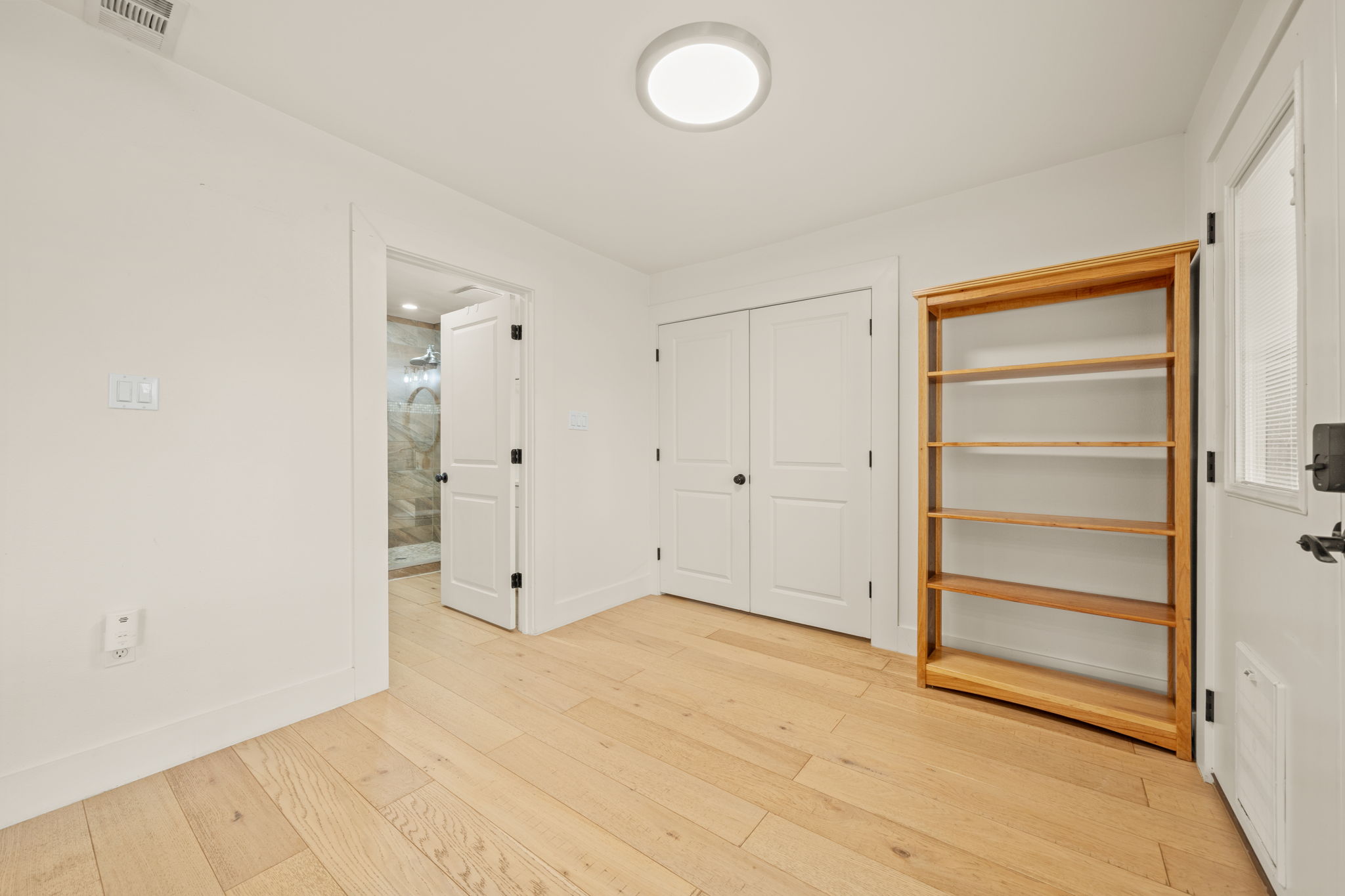 912 Mansell Avenue Austin, TX 78702 - Photo 17 of 37 Unfurnished bedroom featuring a closet and light wood finished floors