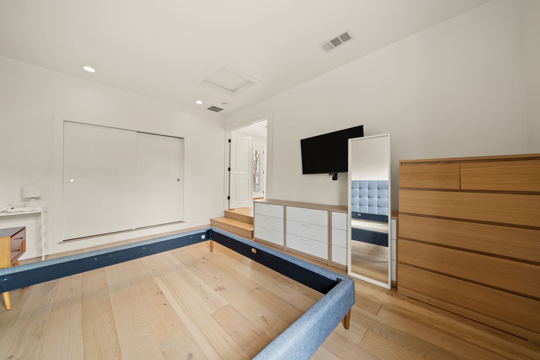 912 Mansell Avenue Austin, TX 78702 - Photo 22 of 37 Unfurnished bedroom featuring light wood-style floors, attic access, and recessed lighting