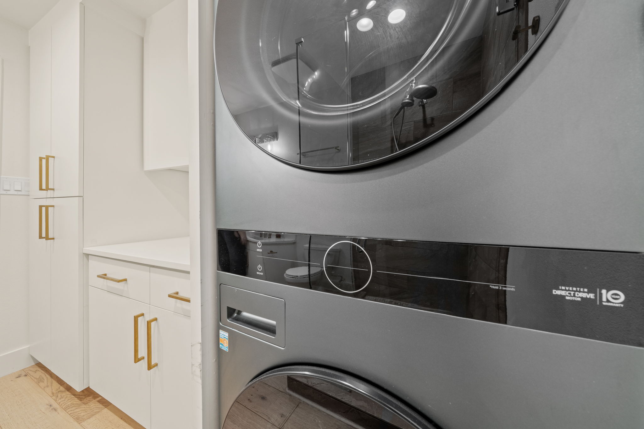 912 Mansell Avenue Austin, TX 78702 - Photo 25 of 37 Laundry room featuring cabinet space and light wood-style floors