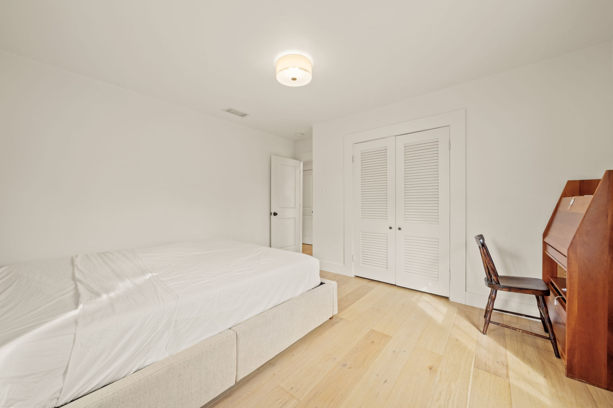 912 Mansell Avenue Austin, TX 78702 - Photo 27 of 37 Bedroom with wood-type flooring and a closet