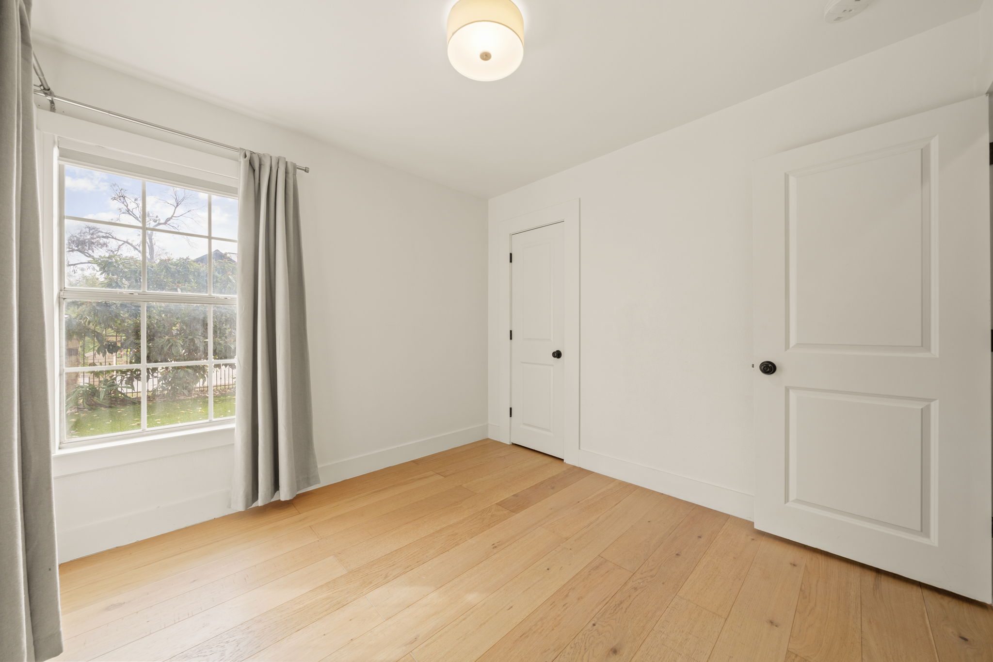 912 Mansell Avenue Austin, TX 78702 - Photo 30 of 37 Unfurnished bedroom with light wood finished floors and baseboards
