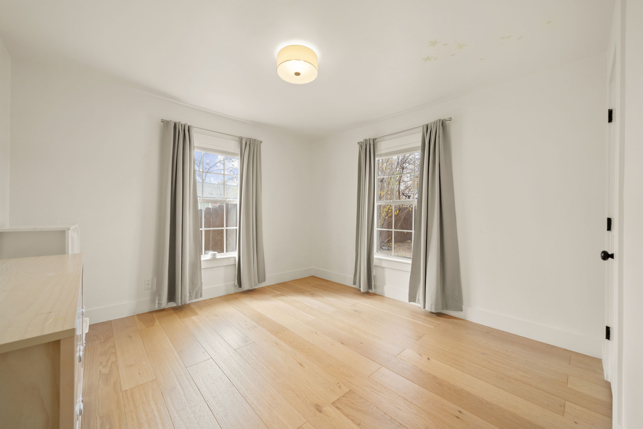 912 Mansell Avenue Austin, TX 78702 - Photo 5 of 37 Empty room featuring plenty of natural light and light wood-type flooring