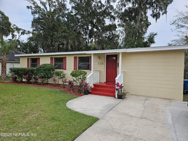 a front view of house with yard and outdoor seating