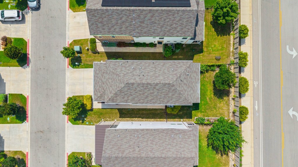7403 Travertine Spring Drive, Unit 117 Austin, TX 78744 - Photo 34 of 37 An aerial perspective reveals the neighborhood layout with houses, streets, and green spaces.