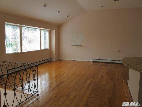 5 Elm Street Great Neck, NY 11021 - Photo 6 of 17 a view of an empty room with wooden floor and a window