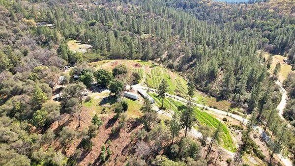 an aerial view of residential house with parking space and trees