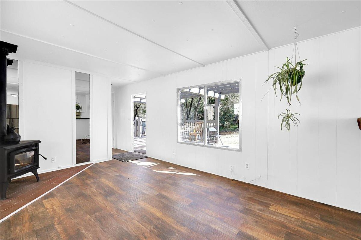 23003 Pleasant Valley Road North San Juan, CA 95960 - Photo 3 of 47 a view of an empty room with a window and wooden floor