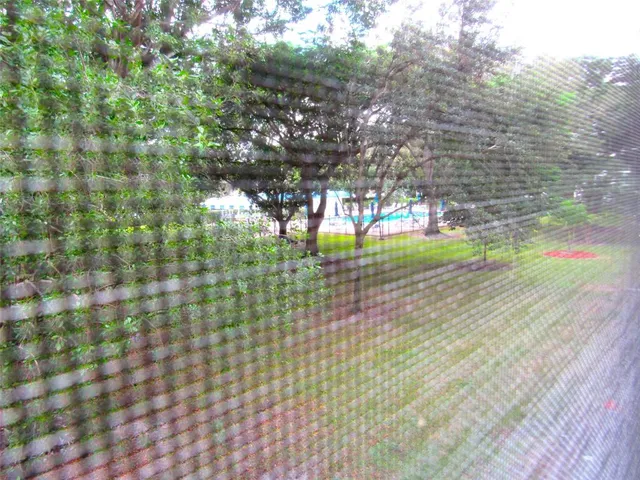 a view of empty room with large trees