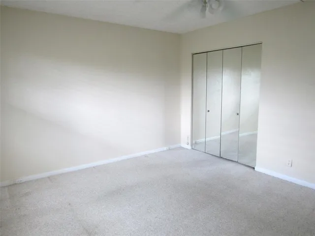 a view of an empty room and closet area