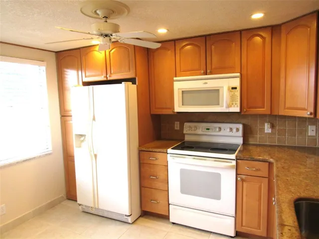 a kitchen with a stove a sink and a refrigerator