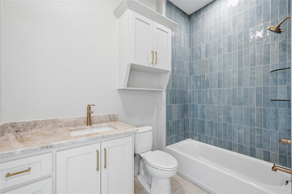 348 Lacek Mill Road China Spring, TX 76633 - Photo 19 of 40 a bathroom with a granite countertop bathtub sink vanity mirror and toilet