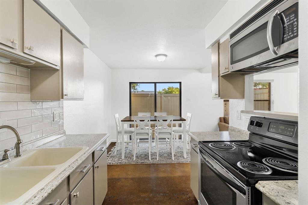 2240 Tarpley Road, Unit 484 Carrollton, TX 75006 - Photo 12 of 20 a kitchen with stainless steel appliances granite countertop a stove and a sink