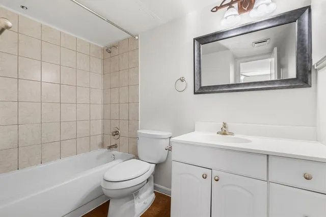 a bathroom with a sink a toilet and mirror