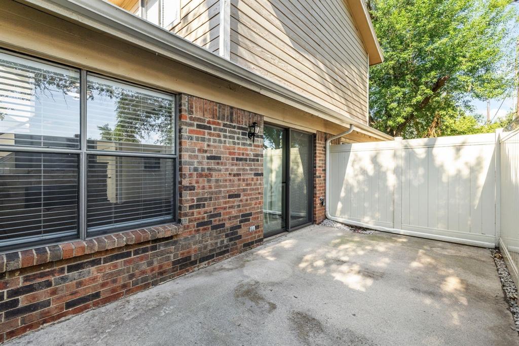 2240 Tarpley Road, Unit 484 Carrollton, TX 75006 - Photo 18 of 20 a view of backyard with window and brick wall