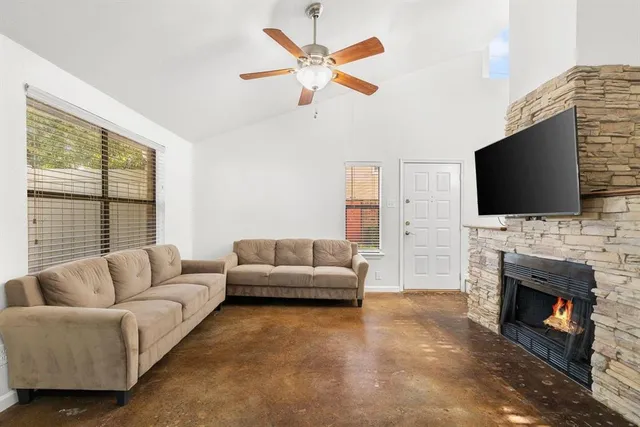 a living room with furniture a fireplace and a flat screen tv