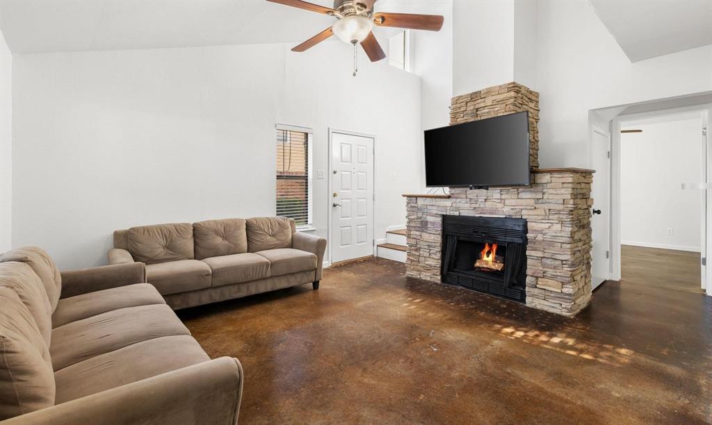 2240 Tarpley Road, Unit 484 Carrollton, TX 75006 - Photo 7 of 20 a living room with furniture a flat screen tv and a fireplace
