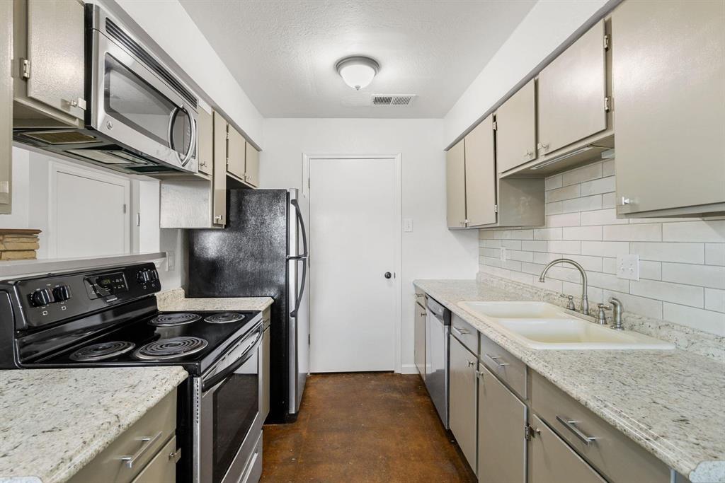 2240 Tarpley Road, Unit 484 Carrollton, TX 75006 - Photo 10 of 20 a kitchen with stainless steel appliances granite countertop a sink stove and refrigerator