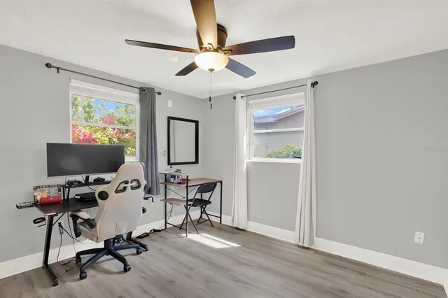 a view of a workspace with furniture and a window