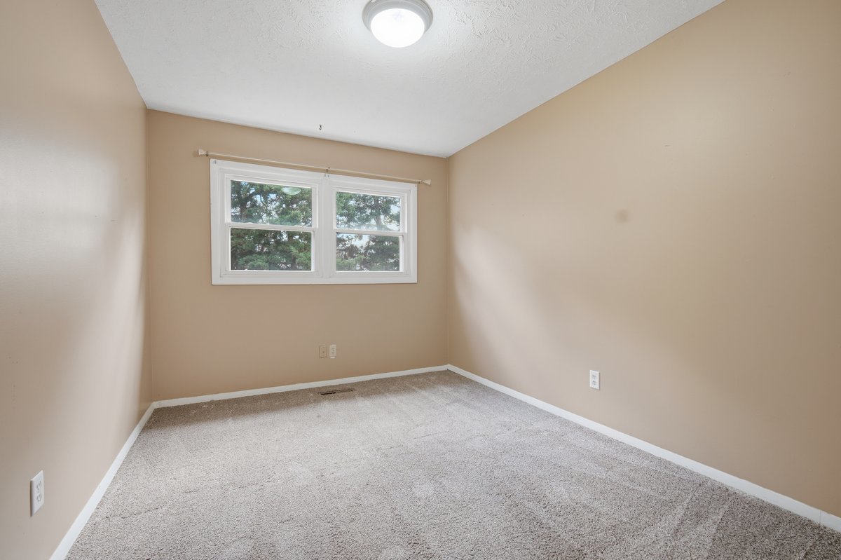 1532 Hunt Drive, Unit A Normal, IL 61761 - Photo 18 of 25 an empty room with a window