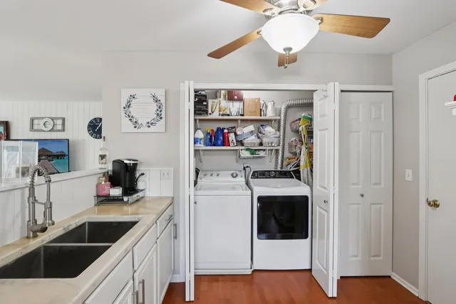 a kitchen with a sink a stove and cabinets