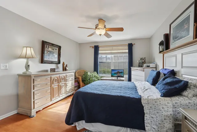 a bedroom with a bed window and dresser