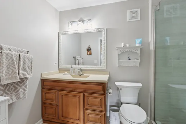 a bathroom with a toilet a sink and mirror