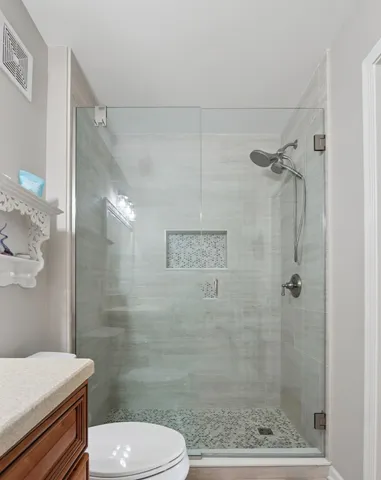 a bathroom with a shower and a toilet