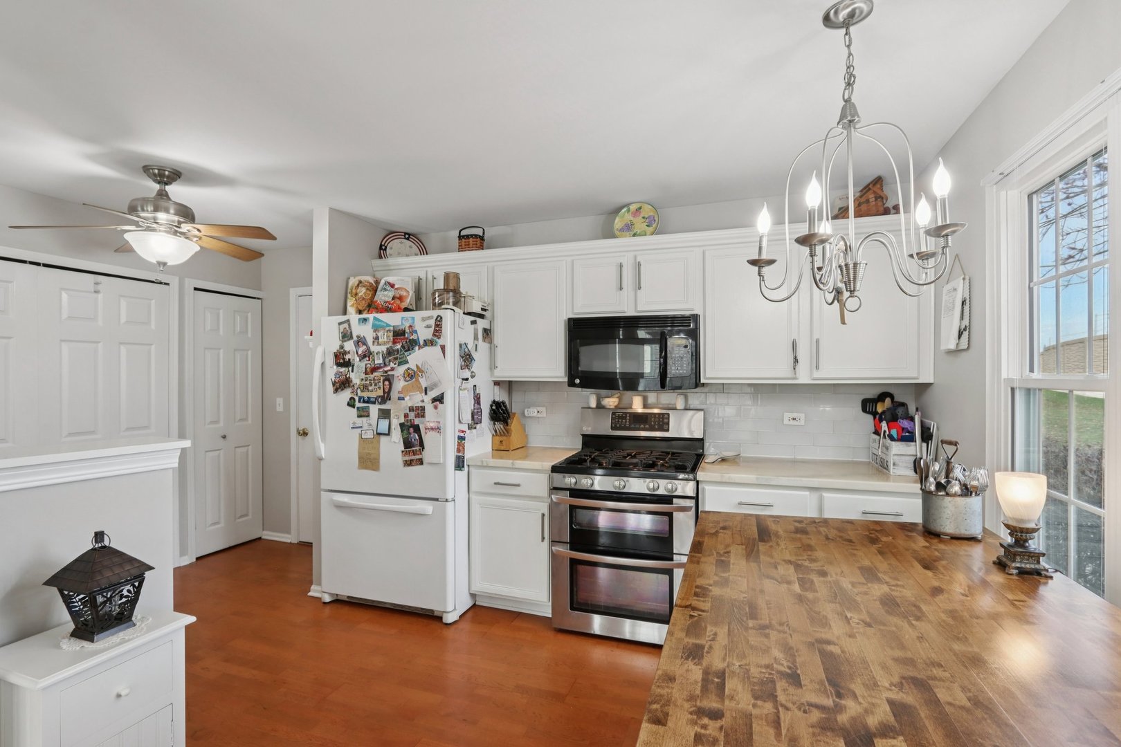 1279 Merrimack Court Crystal Lake, IL 60014 - Photo 7 of 27 a kitchen with stainless steel appliances a stove a refrigerator and cabinets