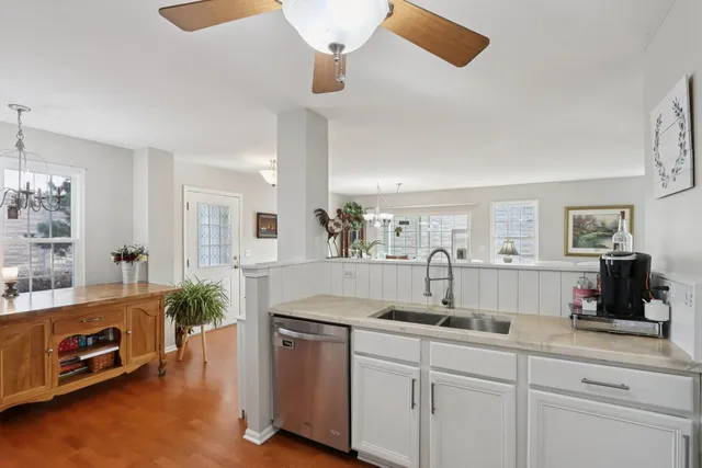 a kitchen with kitchen island granite countertop a sink a counter space and stainless steel appliances