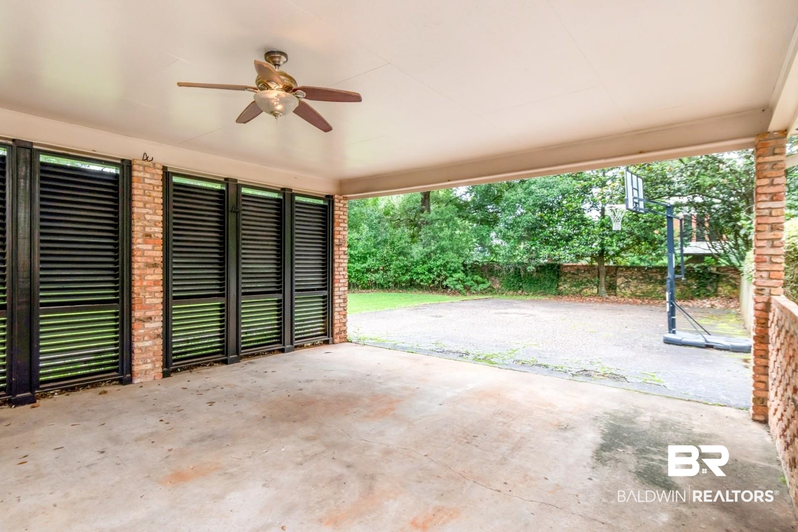 4776 Falls Church Road Mobile, AL 36608 - Photo 30 of 45 Covered outdoor patio featuring a ceiling fan, concrete flooring, brick pillars, and expansive window shutters