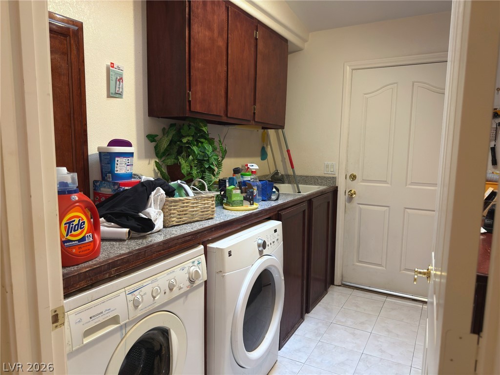 5470 Grain Mill Road Pahrump, NV 89061 - Photo 46 of 80 A functional laundry area includes built-in cabinetry and durable tile flooring.