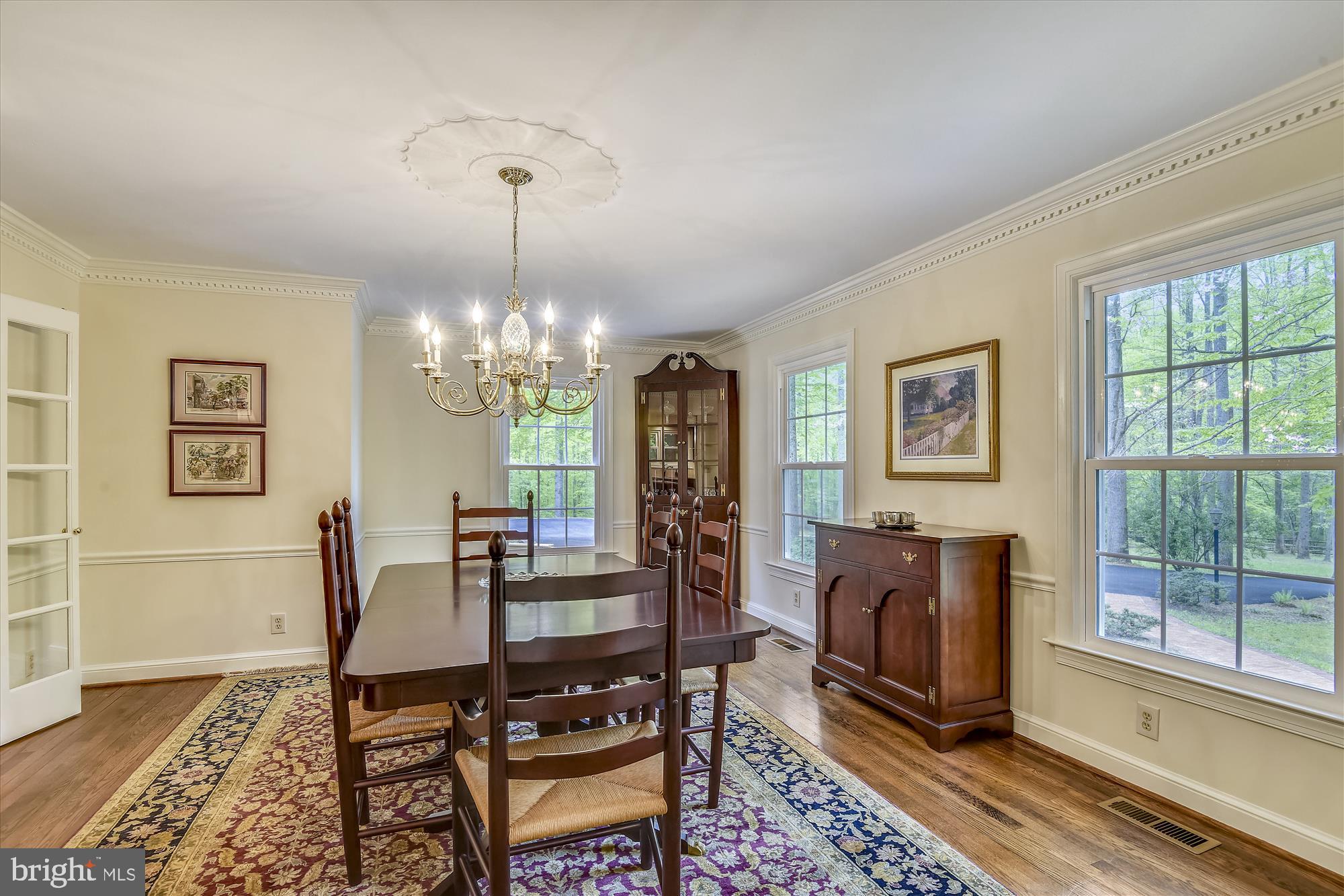 11615 Springtime Lane Fairfax Station, VA 22039 - Photo 17 of 38 a view of a dining room with furniture a chandelier and wooden floor