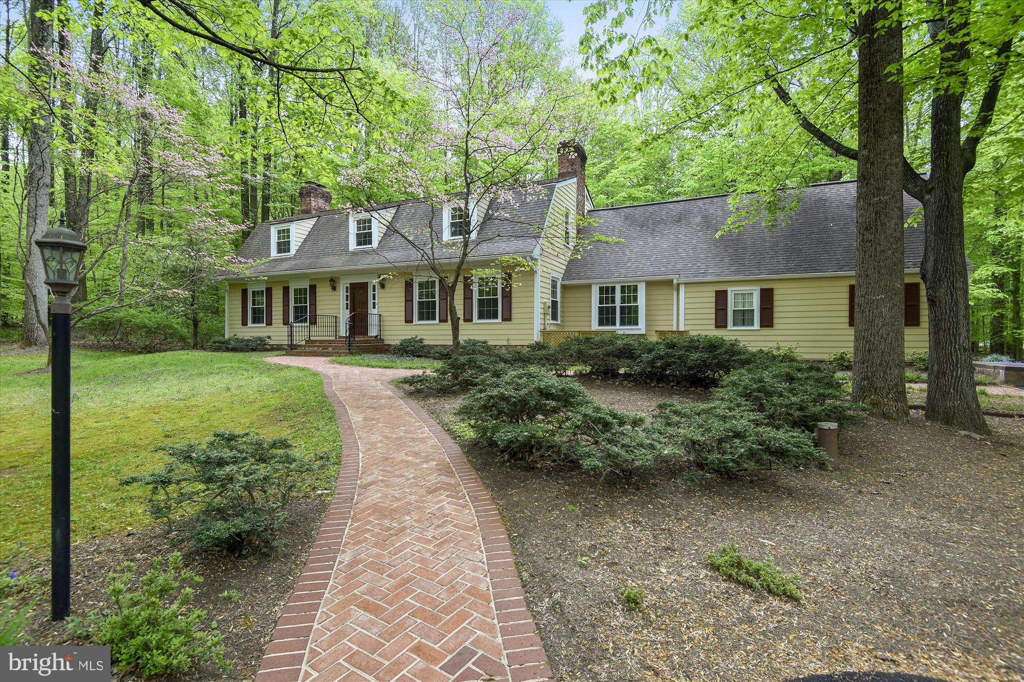 11615 Springtime Lane Fairfax Station, VA 22039 - Photo 35 of 38 a front view of a house with a garden