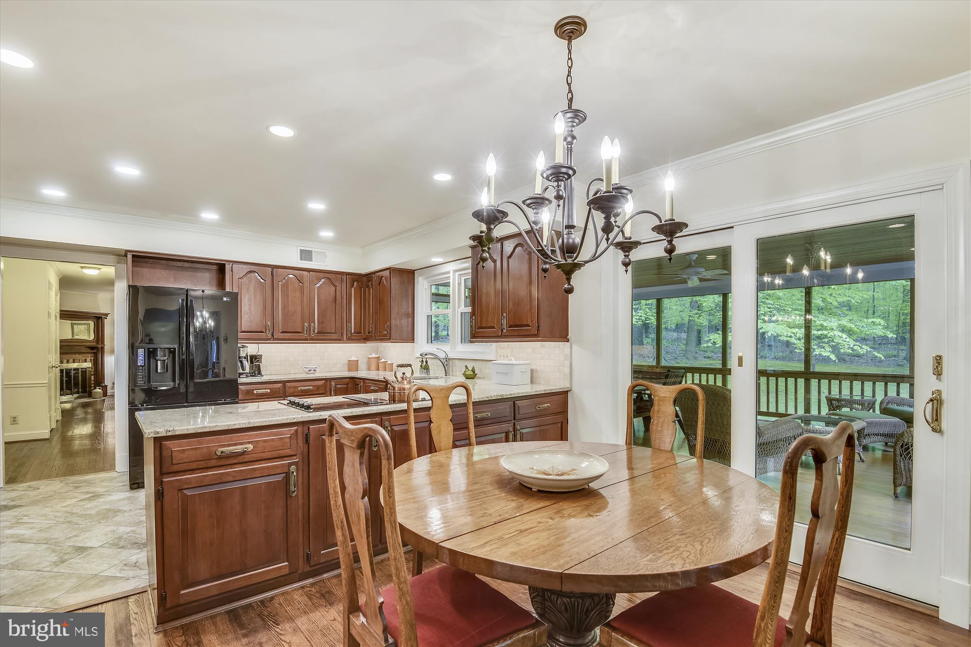 11615 Springtime Lane Fairfax Station, VA 22039 - Photo 7 of 38 a view of a dining room with furniture a chandelier and wooden floor