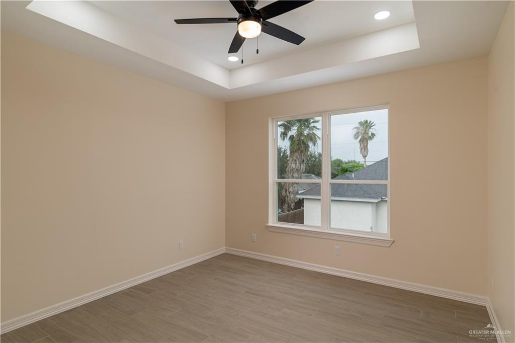 5406 North Crown Point Pharr, TX 78577 - Photo 11 of 14 an empty room with window and ceiling fan