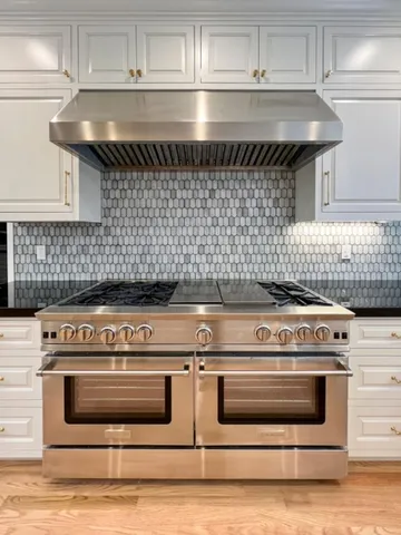 a spacious bedroom with a large bed and a fireplace